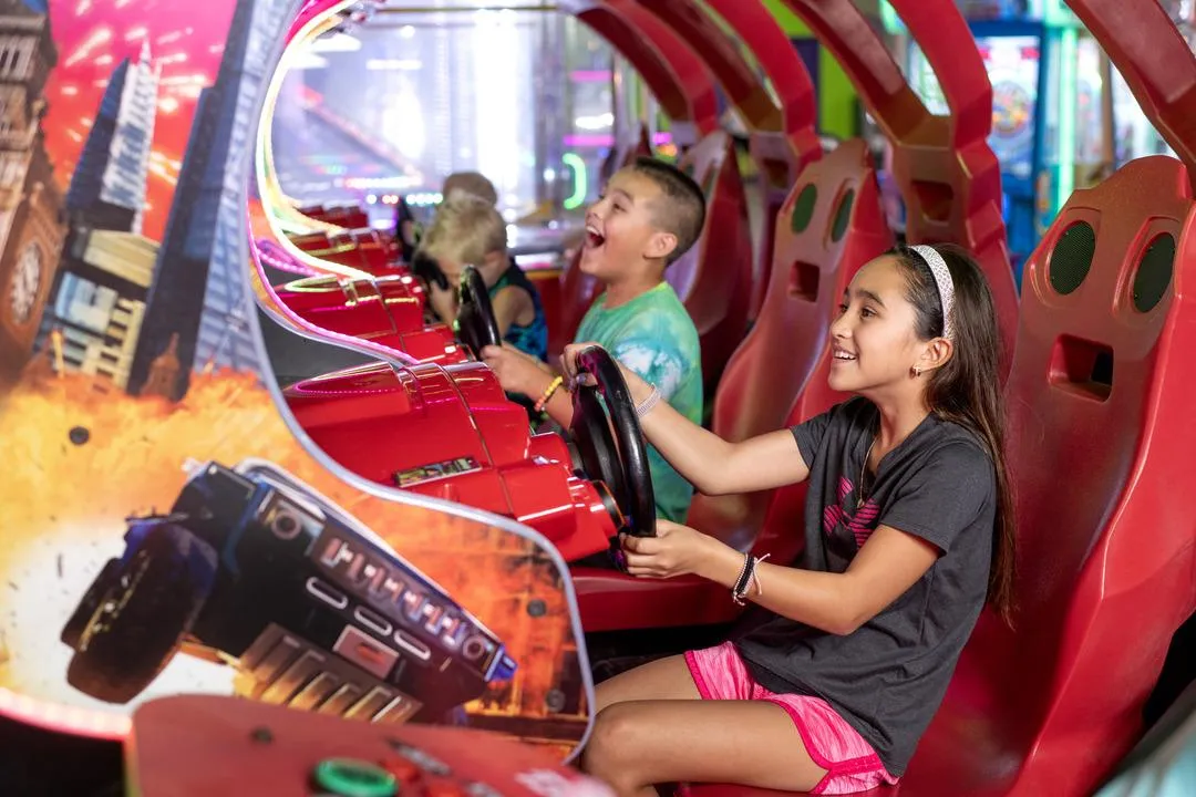 Kids playing racing games in Action City