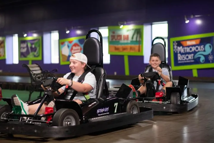 Kids racing on the indoor go-karts in Action City