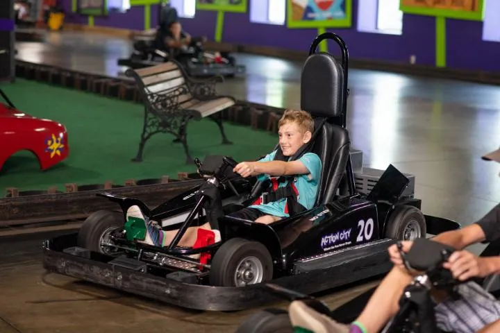 Guests racing go-karts on the indoor track at Action City