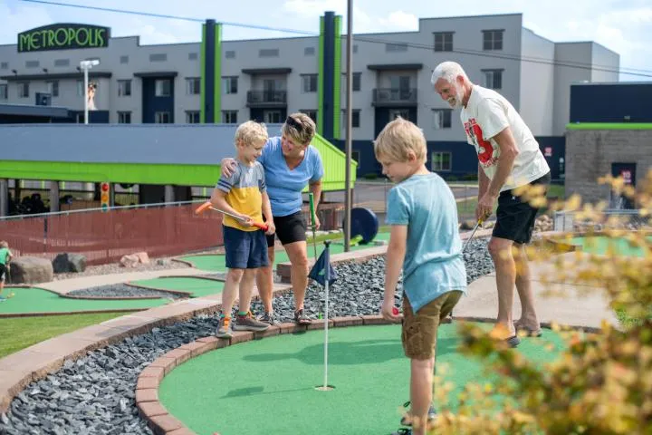 Guests playing mini golf at Action City