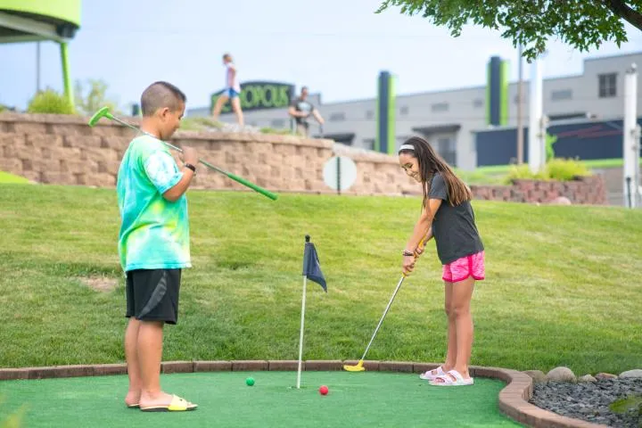 Kids playing mini golf at Action City