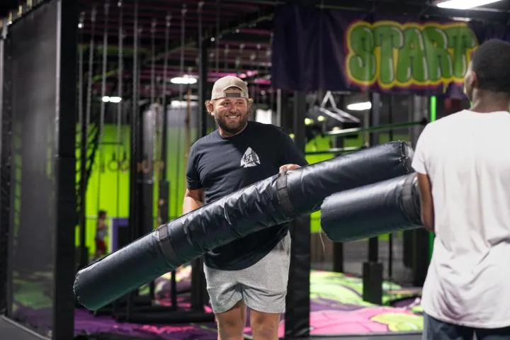 Guests jousting in the trampoline park at Action City