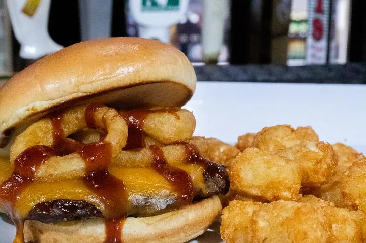 A cheeseburger with onion rings from City Eats