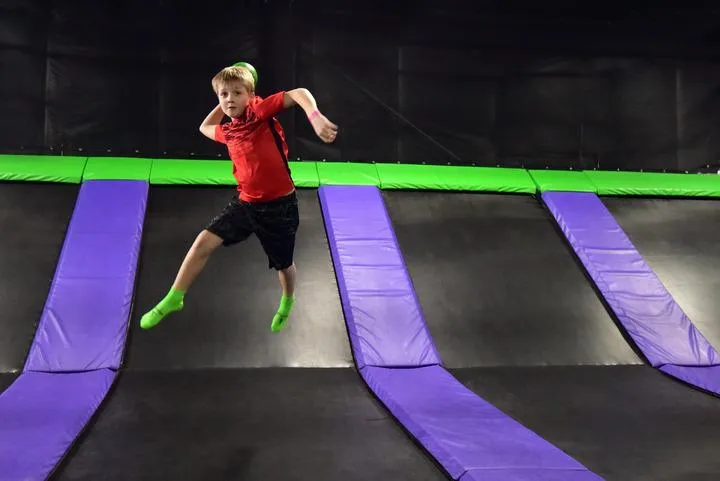 A kid playing dodgeball in the trampoline park at Action City