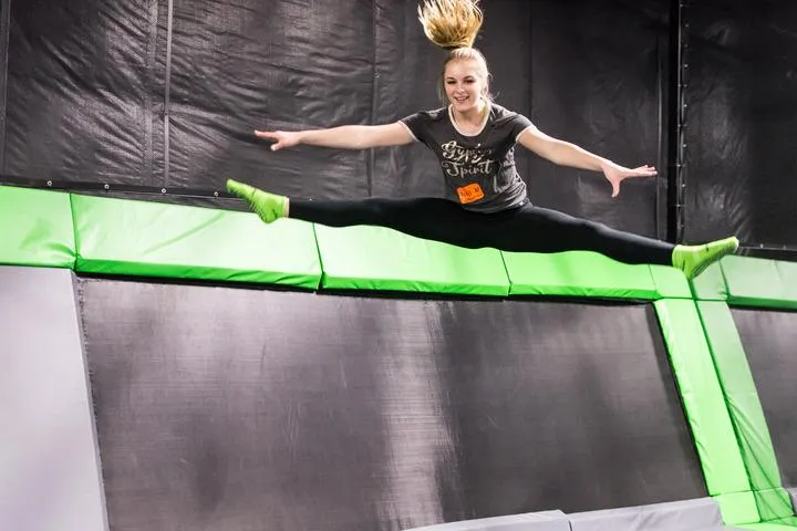 A guest jumping on the open jump court in the trampoline park at Action City