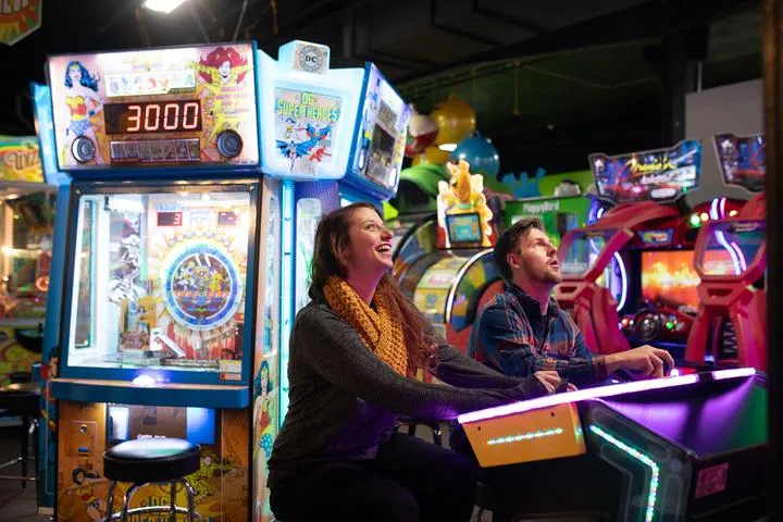 Guests playing arcade games in Action City