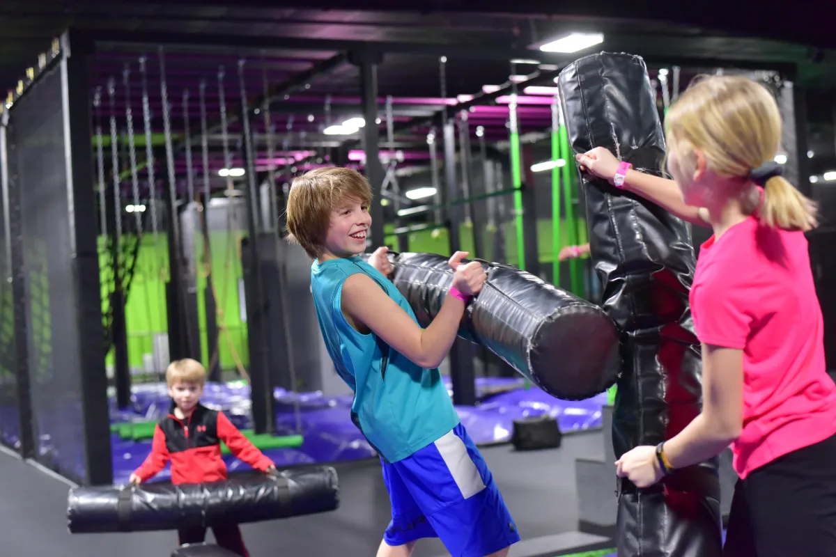 Kids jousting at the trampoline park in Action City