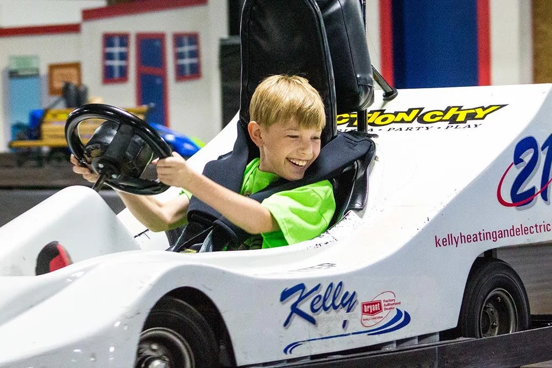 A boy racing on the indoor go-kart track in Action City