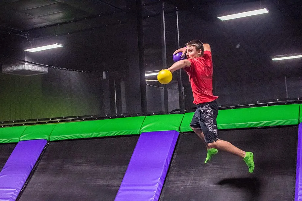 A guest playing dodgeball in the trampoline park at Action City
