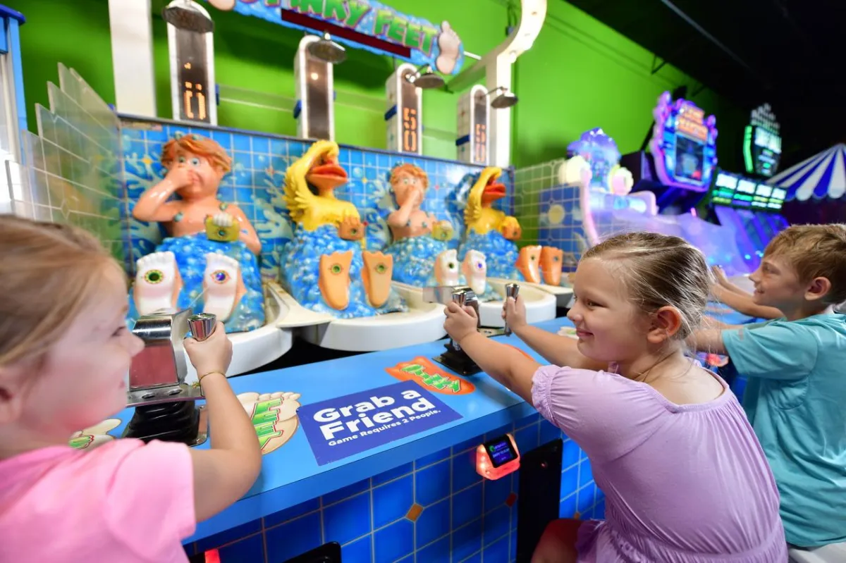 Kids playing the Stinky Feet ame in Action City