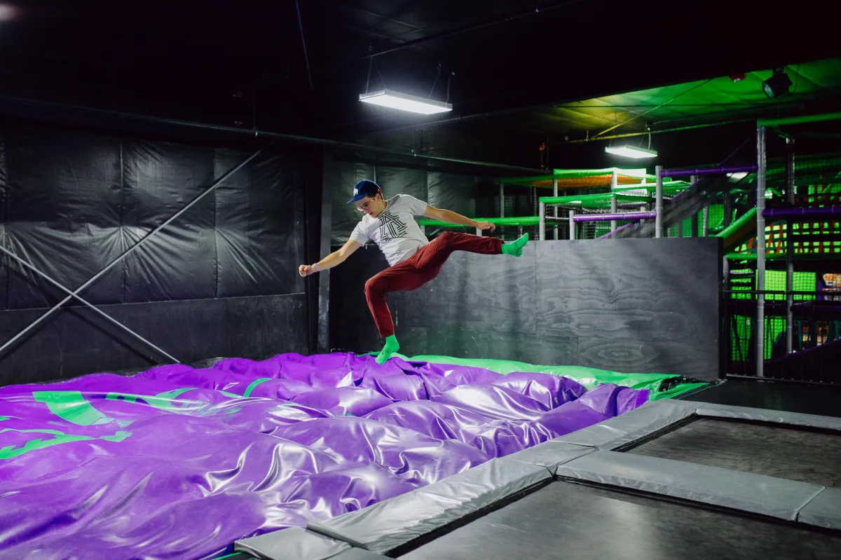 A guest at the airbag stunt jump in the trampoline park at Action City