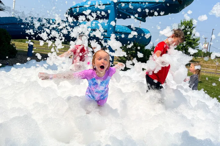 Kids playing in foam in the Chaos Water Park backyard