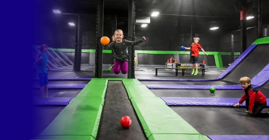 Kids playing dodgeball in the trampoline park at Action City