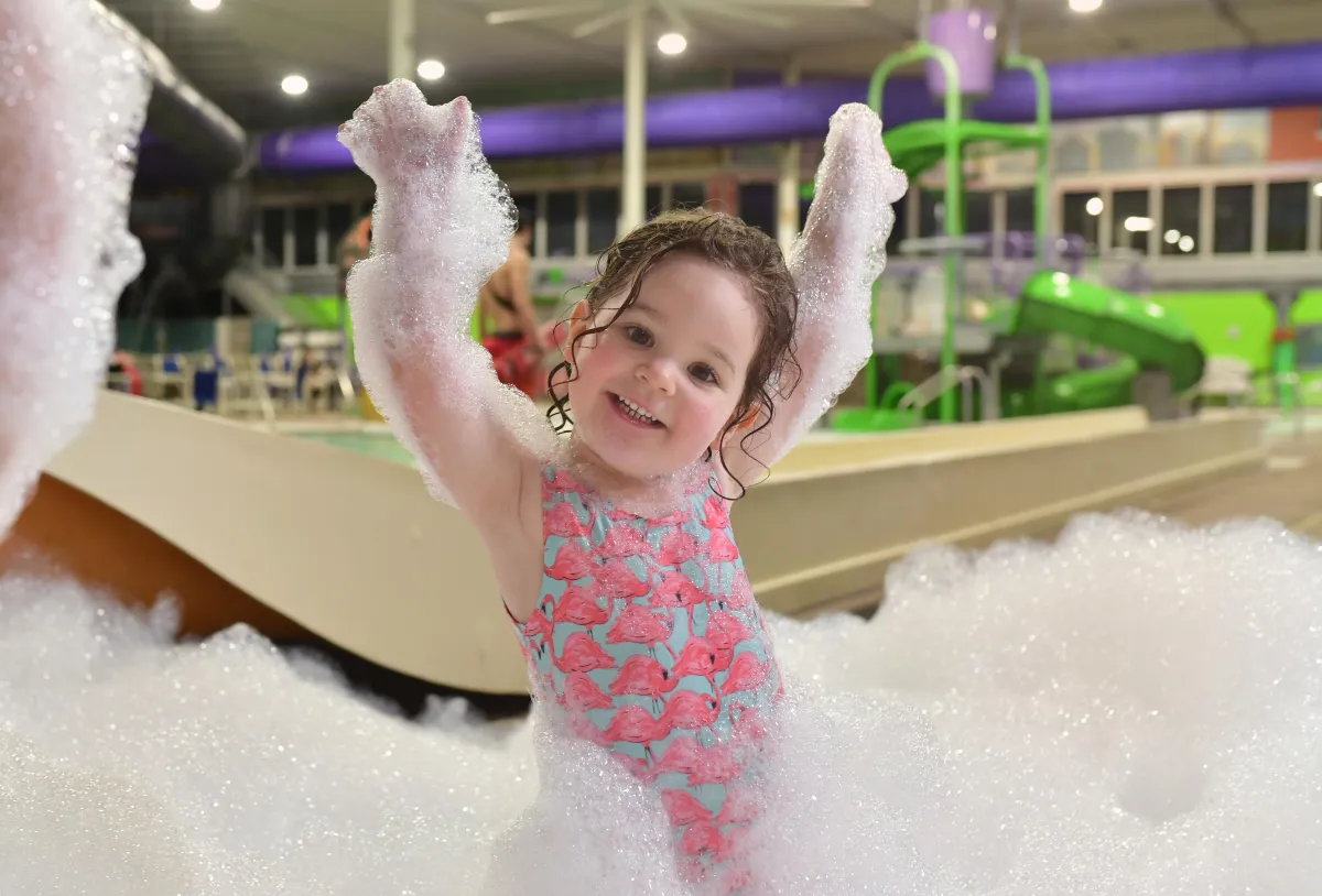 A girl playing in foam at Chaos Water Park
