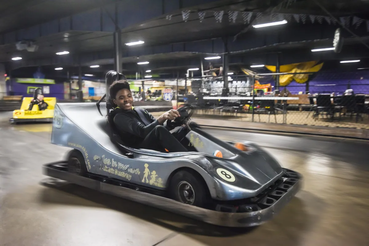 Kids racing on the indoor go-karts in Action City