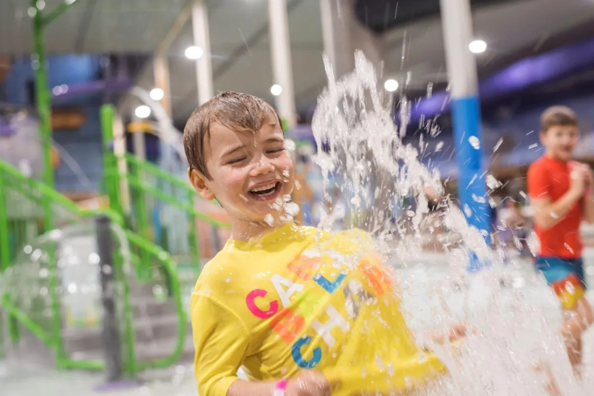 A kid playing in the indoor aquatic playground in Chaos Water Park