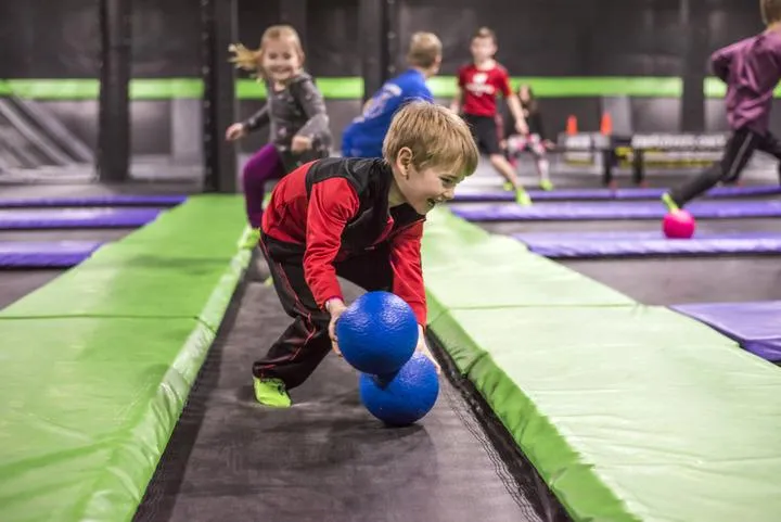 Kids playing dodgeball in the trampoline park at Action City