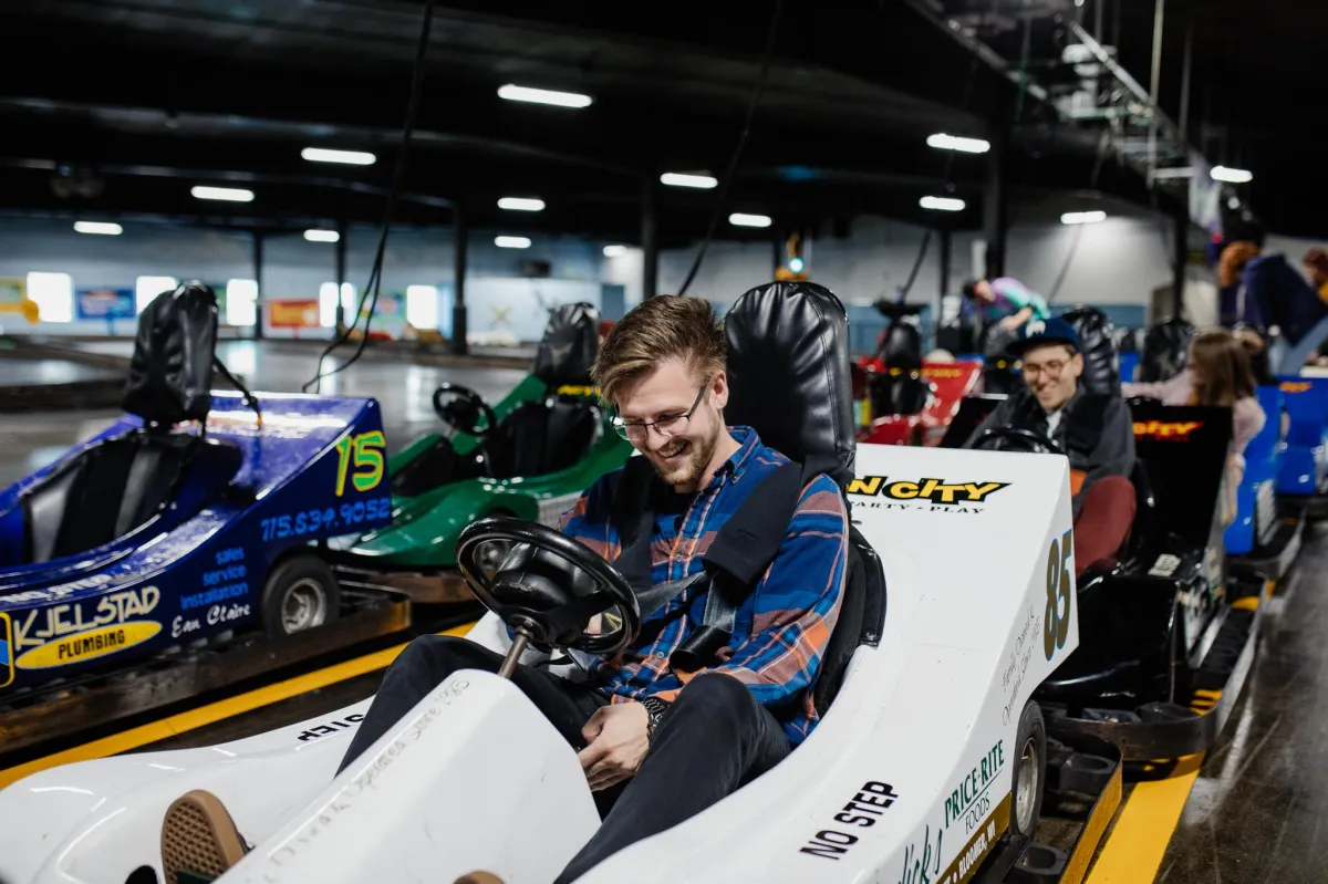 Guests buckling into the indoor go-karts at Action City