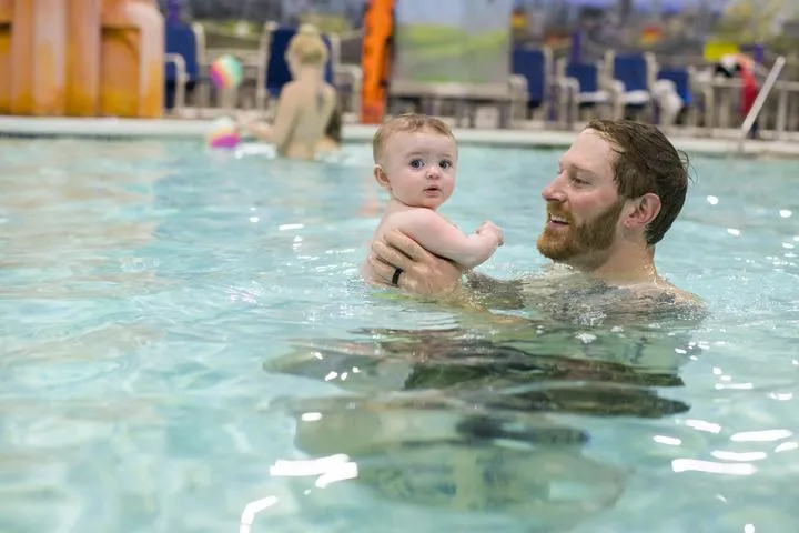 A dad and his son in the pool at Chaos Water Park