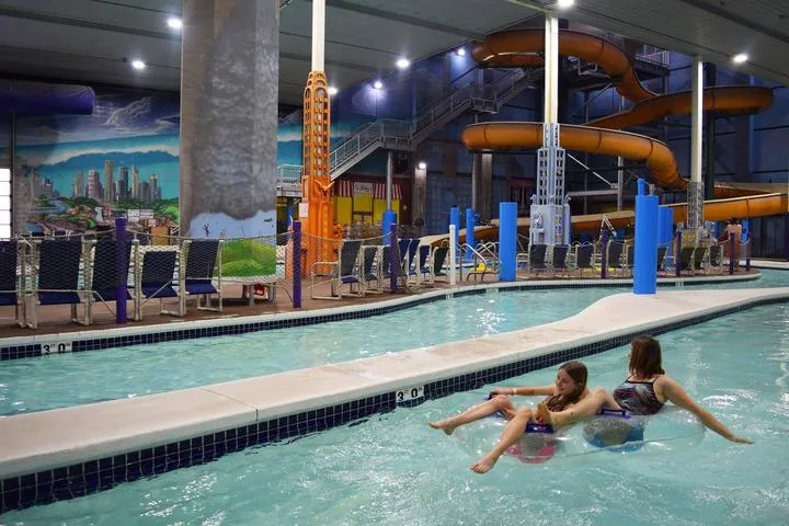 Guests riding tubes in the Tsunami Lazy River at Chaos Water Park