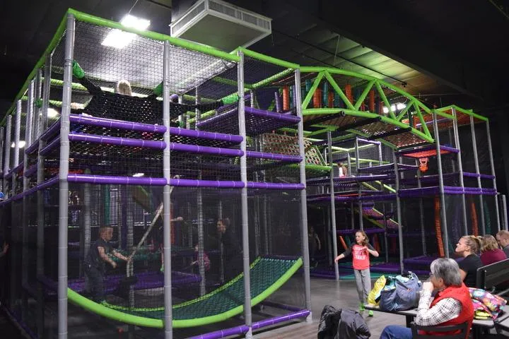 A kid playing on the indoor playground at Action City
