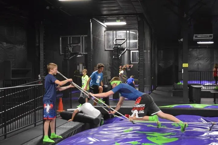 Kids playing on the fidget ladder in Action City's Trampoline Park