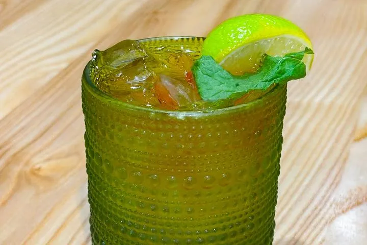 City Eats Mai Tai cocktail with Bacardi Rum, Lime Juice, Grand Mariner, Amaretto, topped with a Myers reserve dark rum float, garnished with a lime wedge, cherry, and mint leaf.