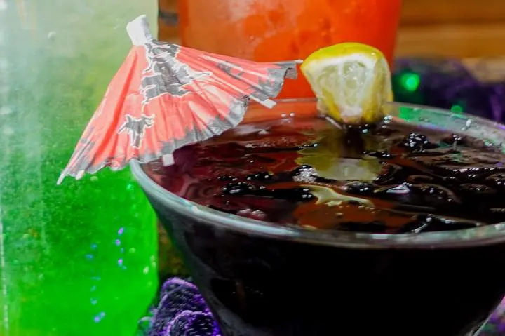 City Eats Blackberry Arnold Palmer cocktail with Crown Royal Blackberry, lemonade, unsweetened tea, garnished with a lemon.
