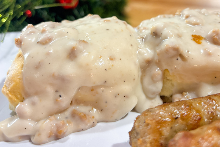 City Eats Beef Brisket Sandwich with cheddar cheese, BBQ, and onion ring on Texas Toast.