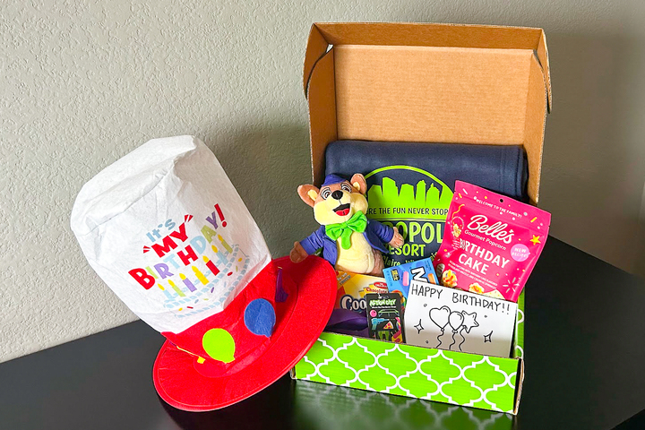 A stuffed animal moose, beach towel, rock candy, and popcorn