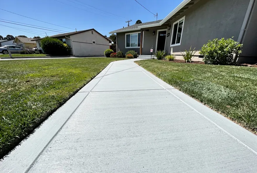 Newly finished concrete sidewalk along the front of a residential home in Redwood City, California