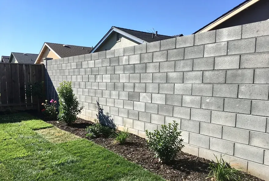 Newly finished concrete block wall along the perimeter of a residential backyard in Redwood City, CA