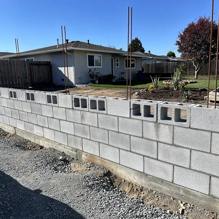 Concrete block wall under construction with rebar visible at a residential property in Redwood City, CA