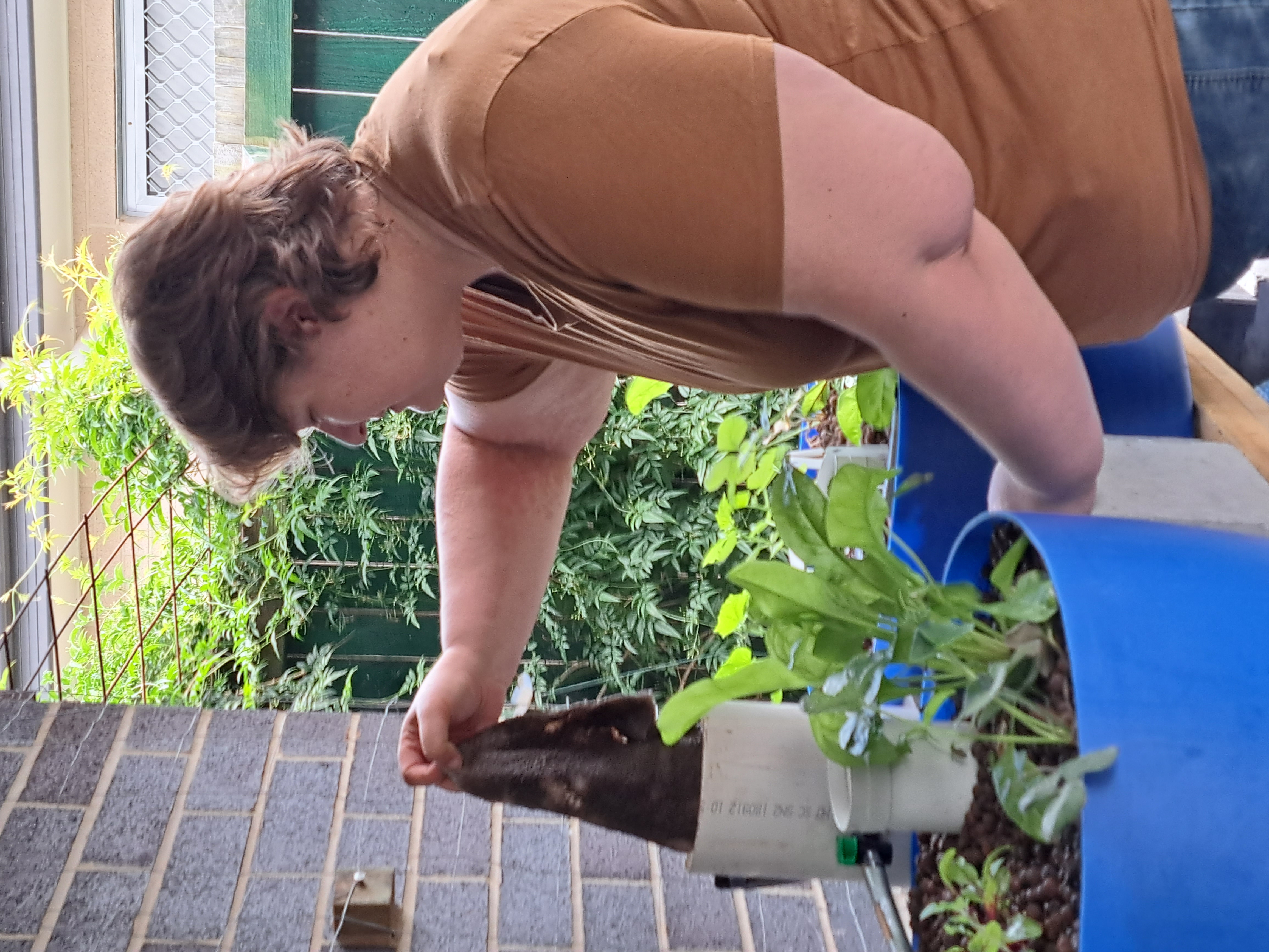 Candy working on a backyard aquaponics system after years of practical experience