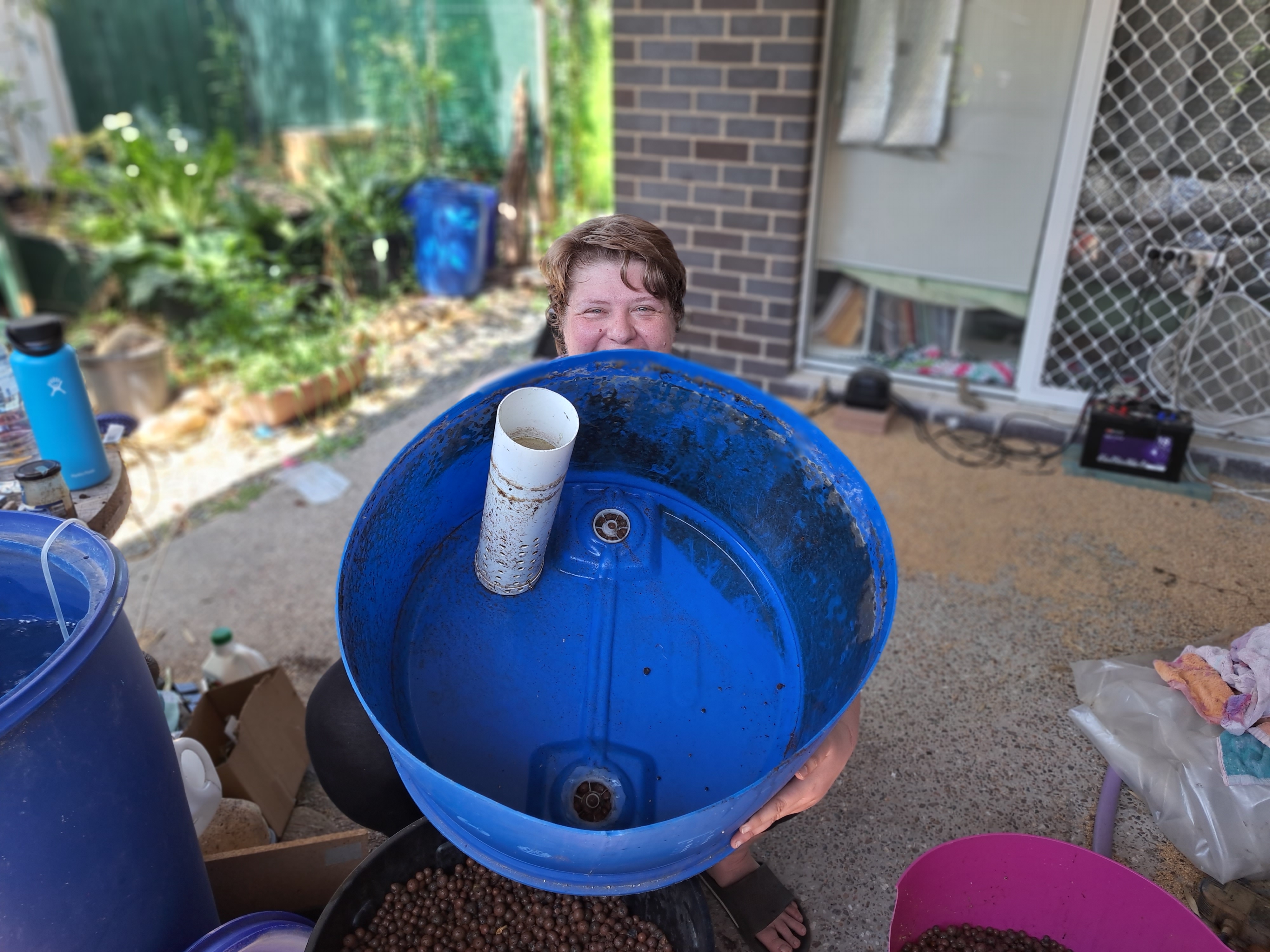 Practical aquaponics system building and plumbing demonstration in a backyard aquaponics course