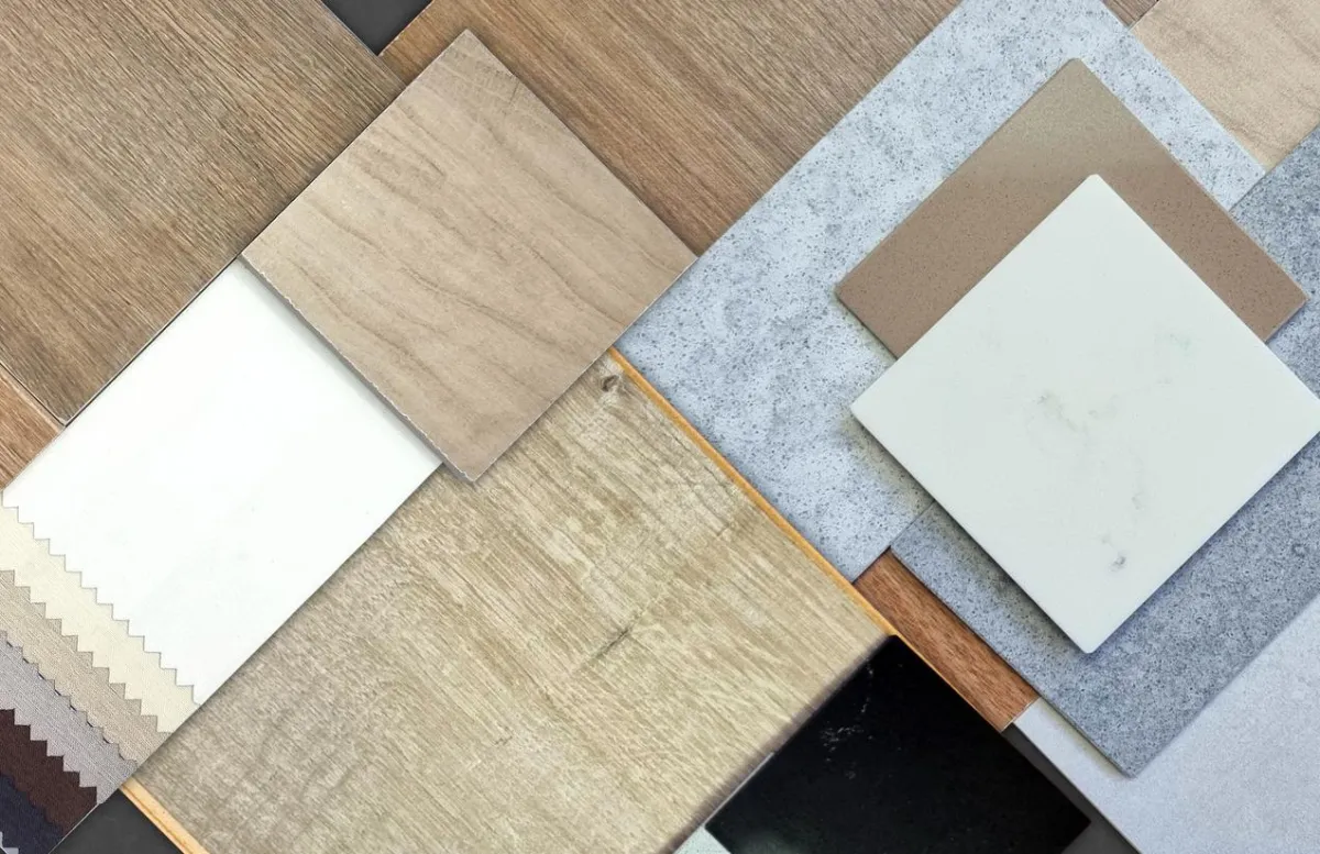 Samples of premium flooring materials: carpet, hardwood, laminate, vinyl, tile, natural stone, rugs