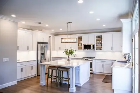 Spacious modern kitchen renovation with white cabinets by Eden Prairie Remodeling Pros.
