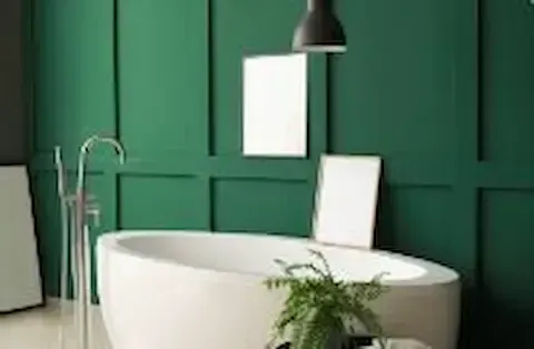 Green accent wall with white freestanding tub after interior painting by Eden Prairie Remodeling Pros.