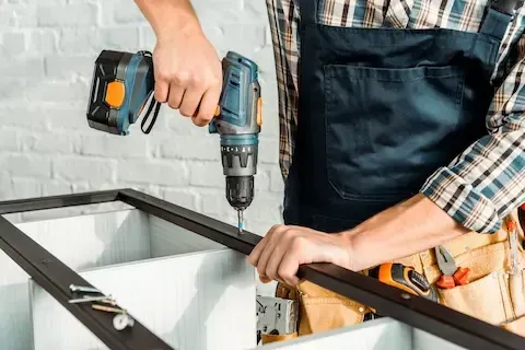 Contractor using power drill during residential remodeling by Eden Prairie Remodeling Pros.