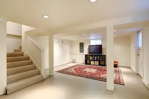 Finished basement with carpeted stairs and recessed lighting by Eden Prairie Remodeling Pros.