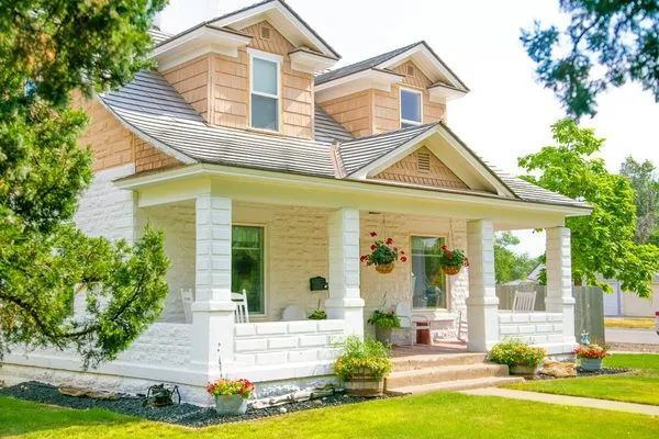 White stone house with a covered front porch