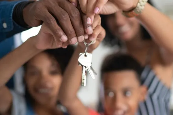 Family holding the keys to their new home
