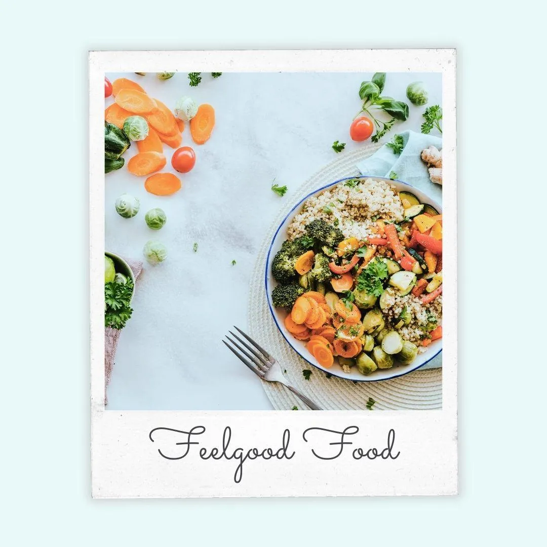A bowl of nourishing vegetables and quinoa on a pale background