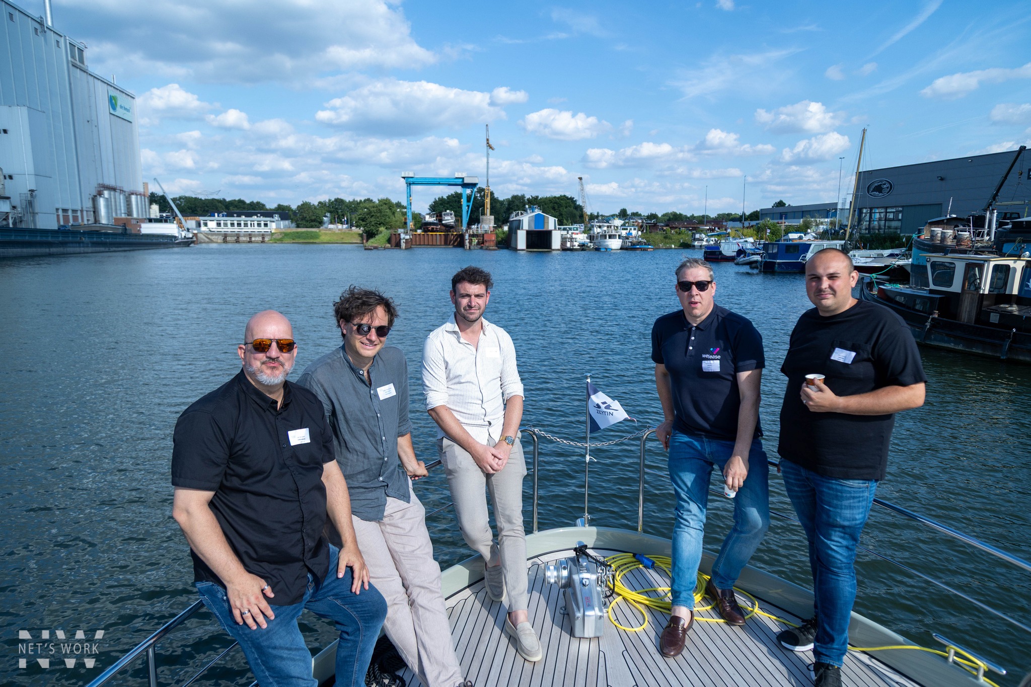 Cropped image of a speaker leading a small professional workshop with participants taking notes, conveying learning and engagement.