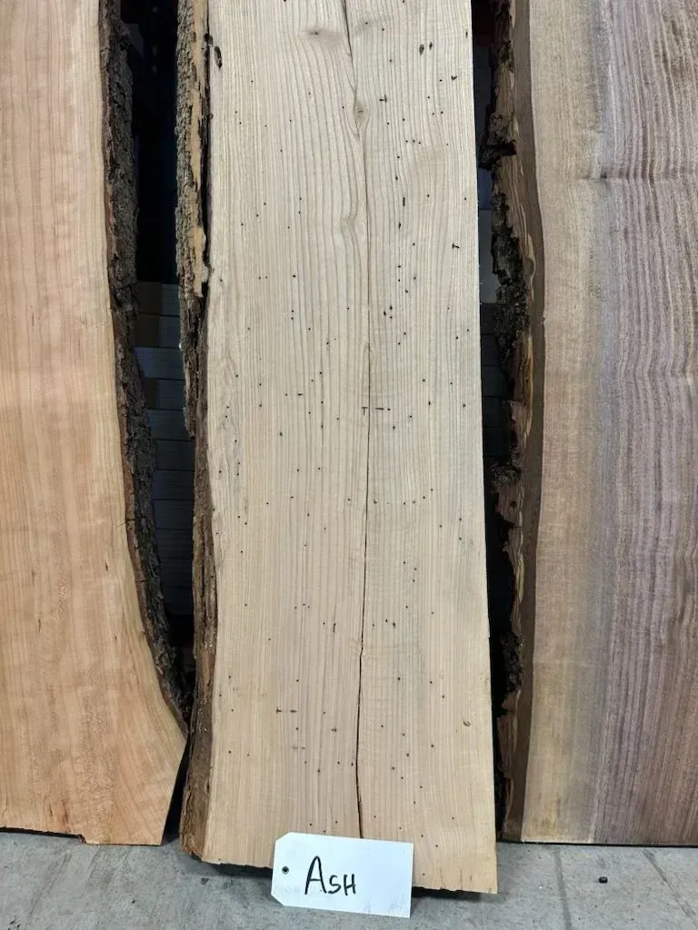Close-up of ash wood from Riverside Logging and Sawmill, showcasing its pale color and excellent strength-to-weight ratio, commonly used in sports equipment, tool handles, and fine furniture.