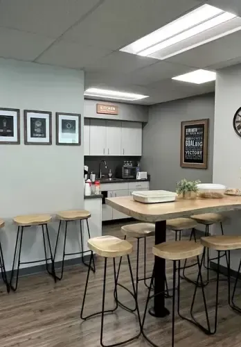 Testimonial from Krista Mahon recommending Riverside Logging and Sawmill for their high-quality ash wood, praising its sleek appearance, durability, and how it enhanced her office renovation project with unique grain patterns.