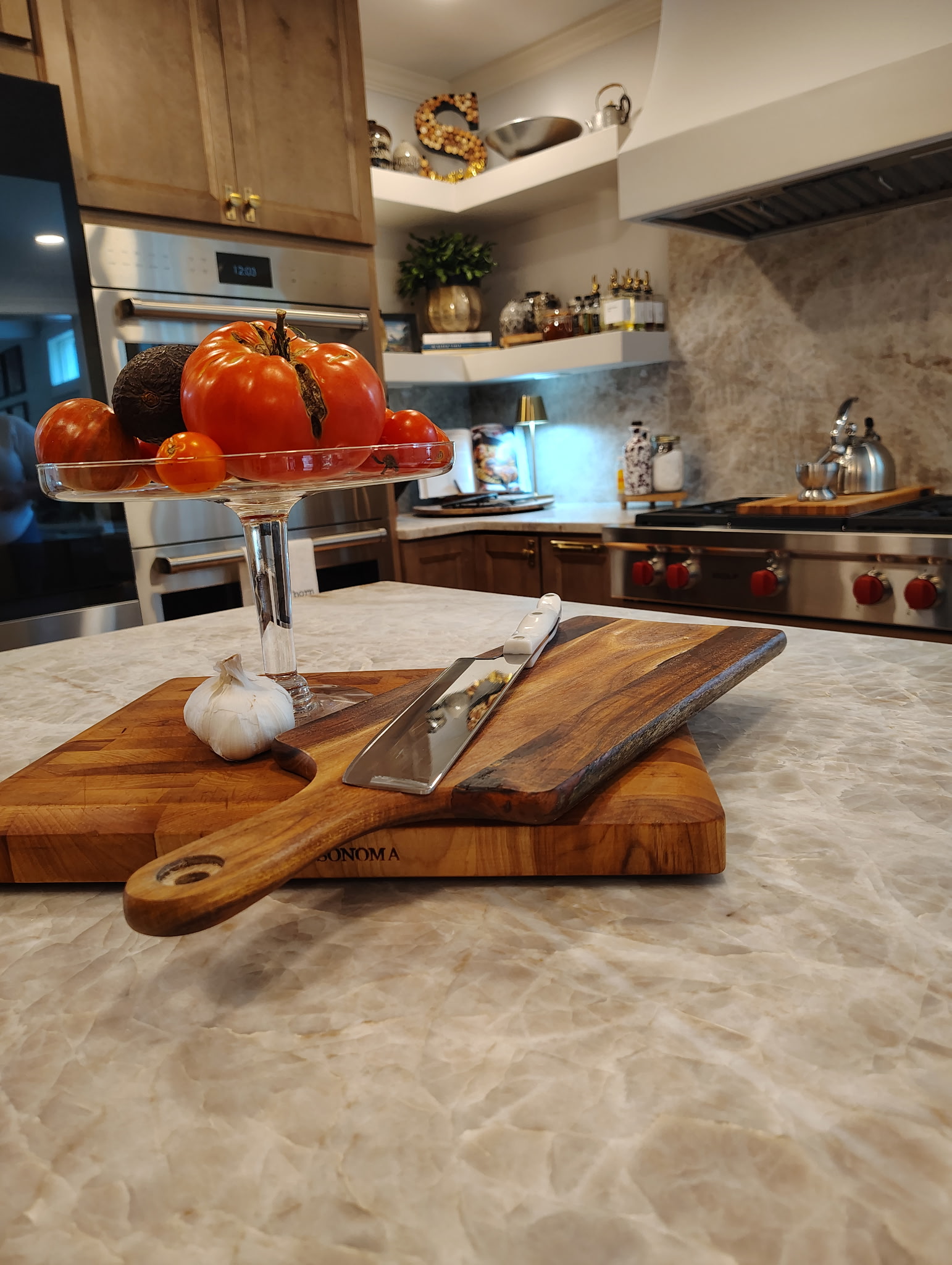 a large kitchen with a marble island and white cabinets