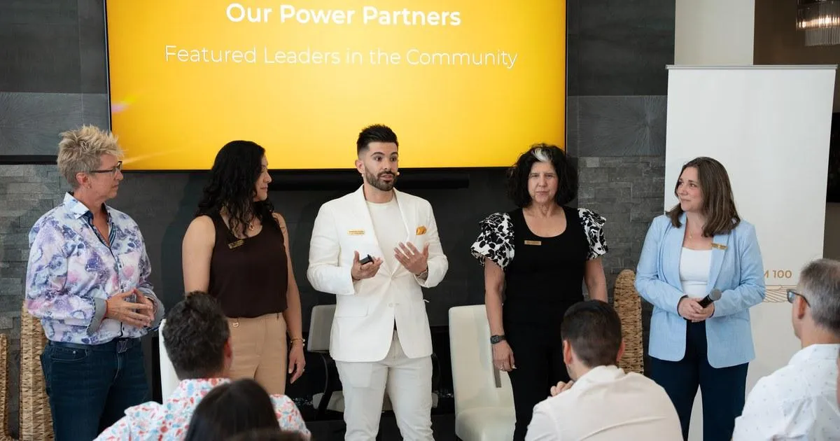 Business leaders presenting community partnerships and peer collaboration at a professional networking event.