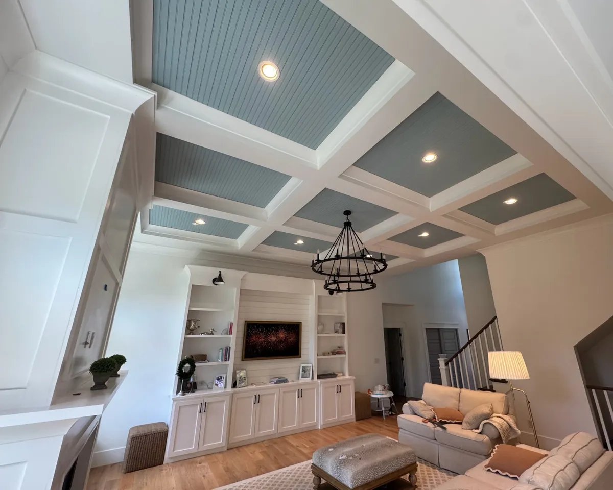 Custom painted coffered ceiling with soft blue inset panels, white trim, and detailed interior finishing in a St. Louis home.