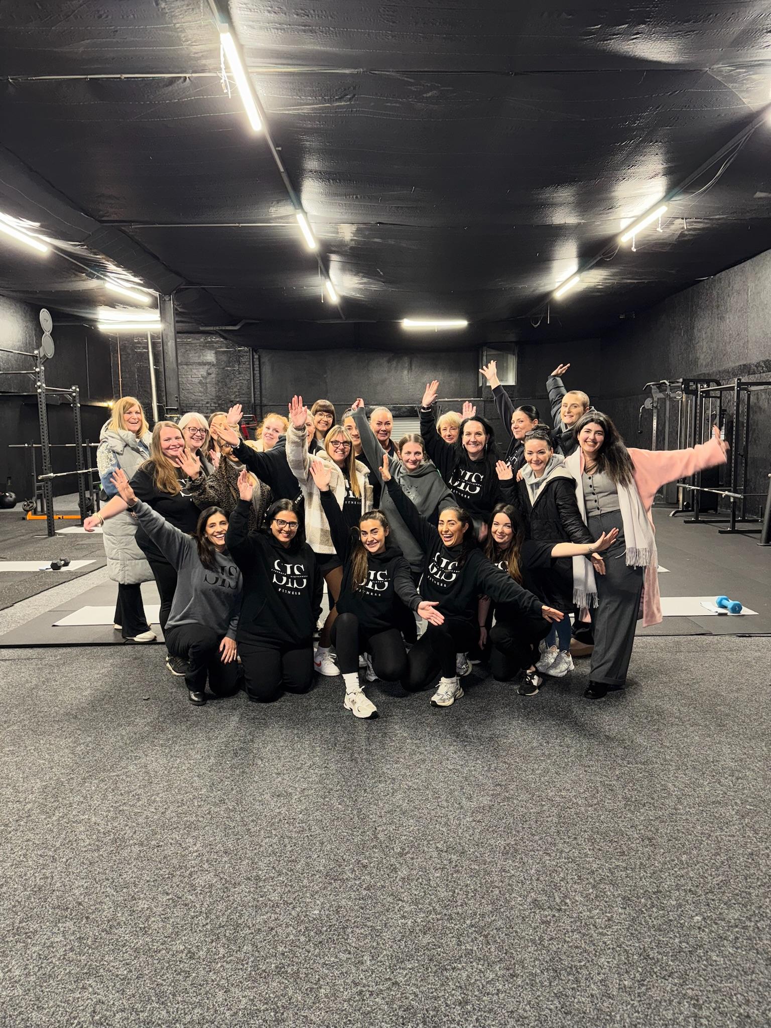 Women training in a supportive gym environment